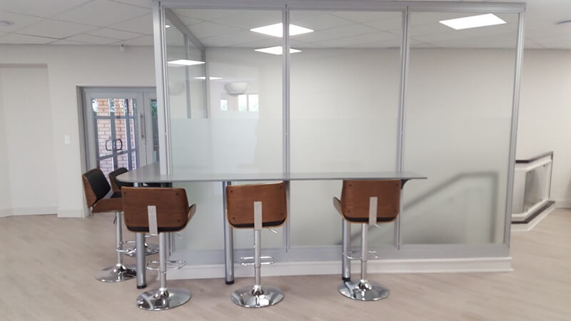 Floor to ceiling partitioning with bar chairs Floor to ceiling partitioning with bar chairs