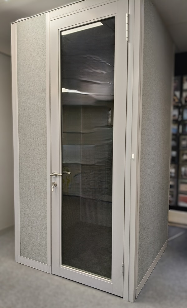 A closed PRIVA-C54 POD with a glass door, designed for private and soundproofed workspace solutions in open office environments.
